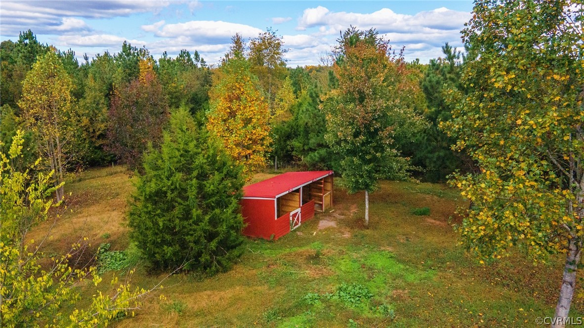 552 Waltons Store Road Louisa, VA 23093 - Photo 17 of 50 a backyard of a house with large trees and a barn
