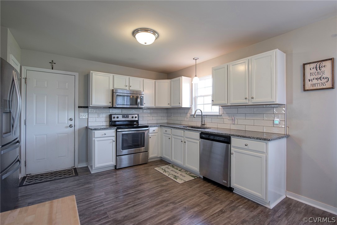 552 Waltons Store Road Louisa, VA 23093 - Photo 26 of 50 a kitchen with granite countertop white cabinets and stainless steel appliances