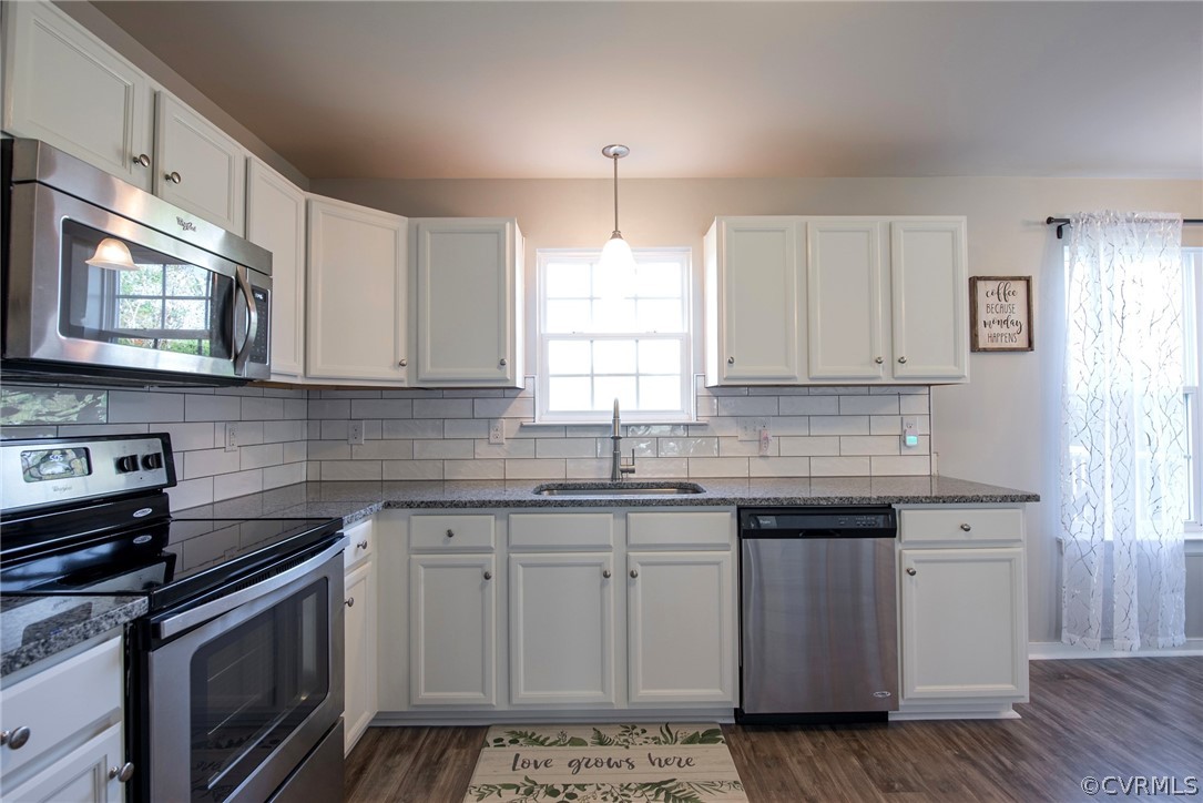 552 Waltons Store Road Louisa, VA 23093 - Photo 27 of 50 a kitchen with stainless steel appliances granite countertop a sink stove and cabinets