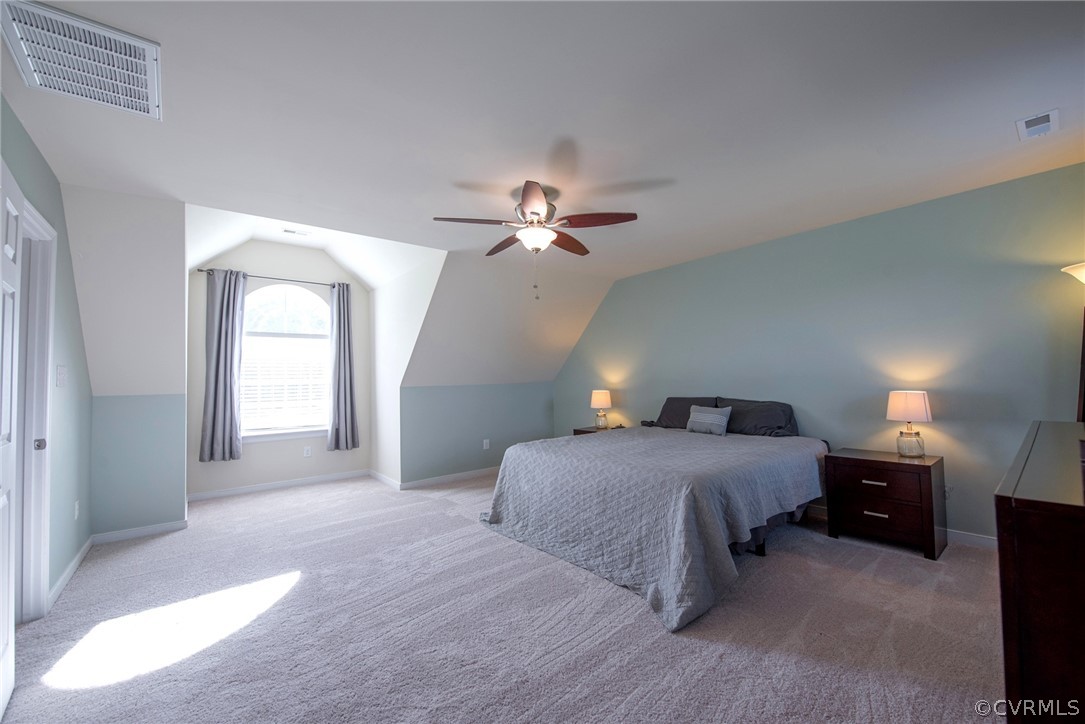 552 Waltons Store Road Louisa, VA 23093 - Photo 33 of 50 a spacious bedroom with a bed and a chandelier