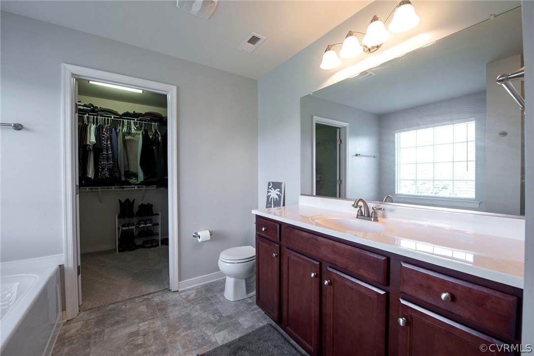 552 Waltons Store Road Louisa, VA 23093 - Photo 38 of 50 a spacious bathroom with a granite countertop sink and a mirror