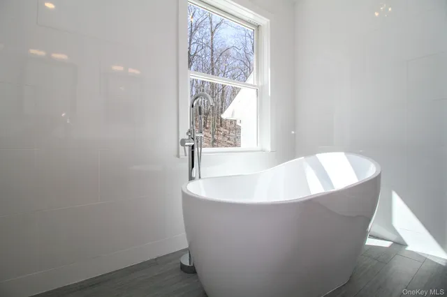 a white bath tub sitting in a bathroom