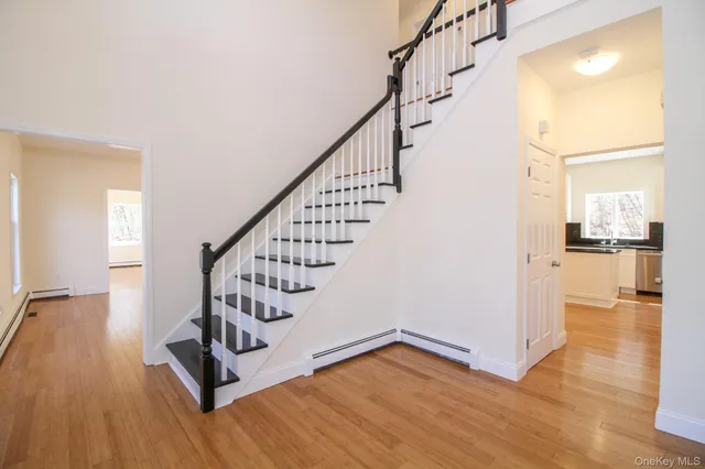 a view of an entryway with wooden floor