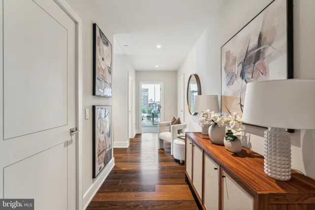 a living room with furniture and a mirror