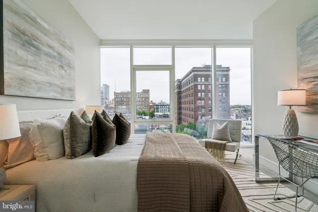 a bedroom with a bed and a chair