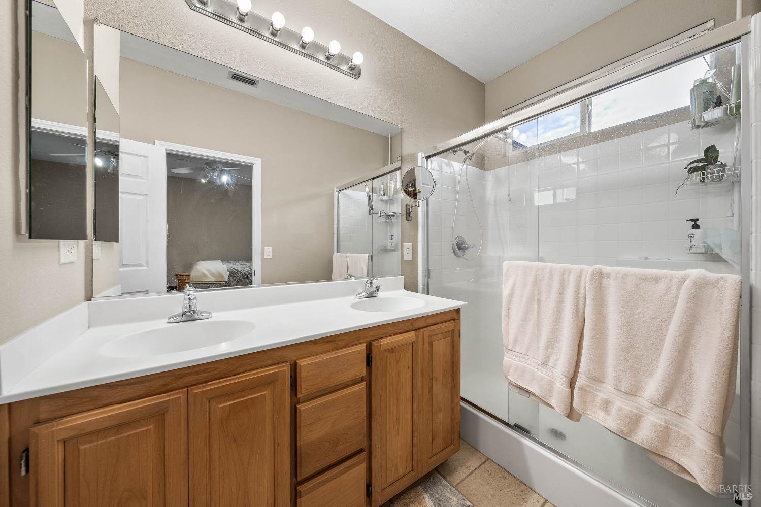 2545 Thistle Creek Street Santa Rosa, CA 95404 - Photo 37 of 59 a bathroom with a double vanity sink and mirror