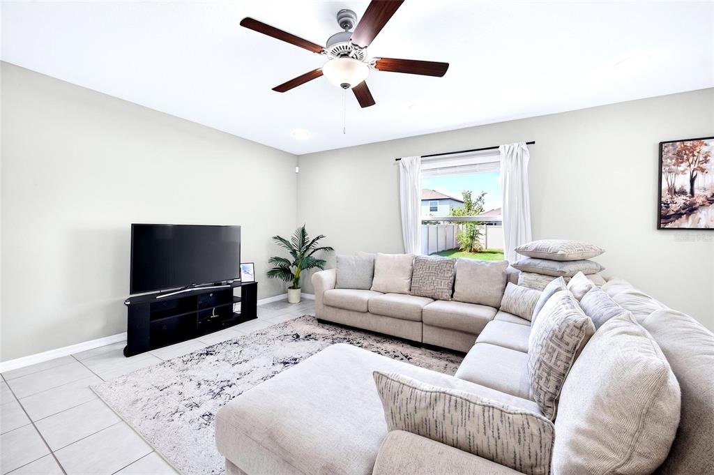 31724 Sun Kettle Loop Wesley Chapel, FL 33545 - Photo 13 of 49 a living room with furniture and a flat screen tv