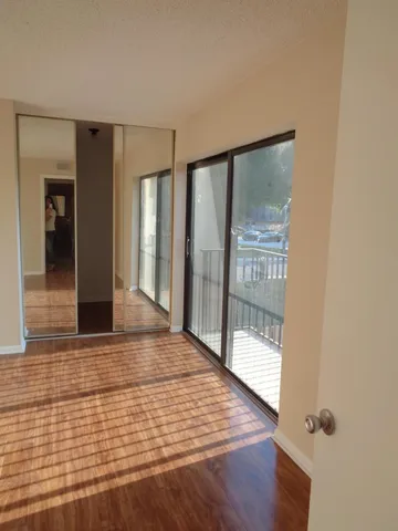 a view of an empty room with glass door