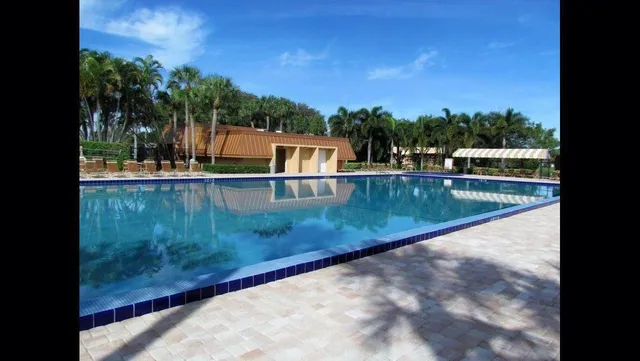a view of a swimming pool with an outdoor seating