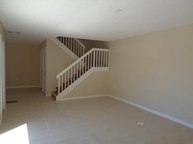 a view of an empty room with stairs