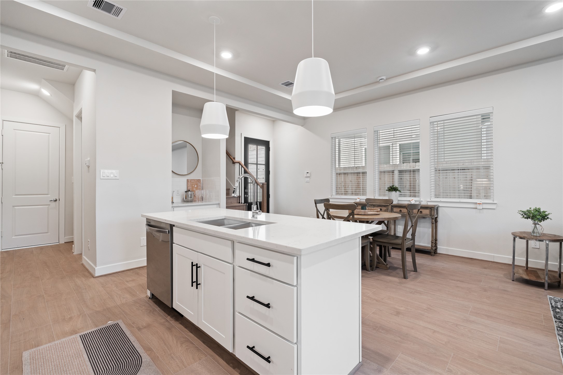 6503 Rena Street Houston, TX 77092 - Photo 10 of 33 Swiss engineered hardwood runs throughout the first floor, adding warmth that balances the clean white finishes.