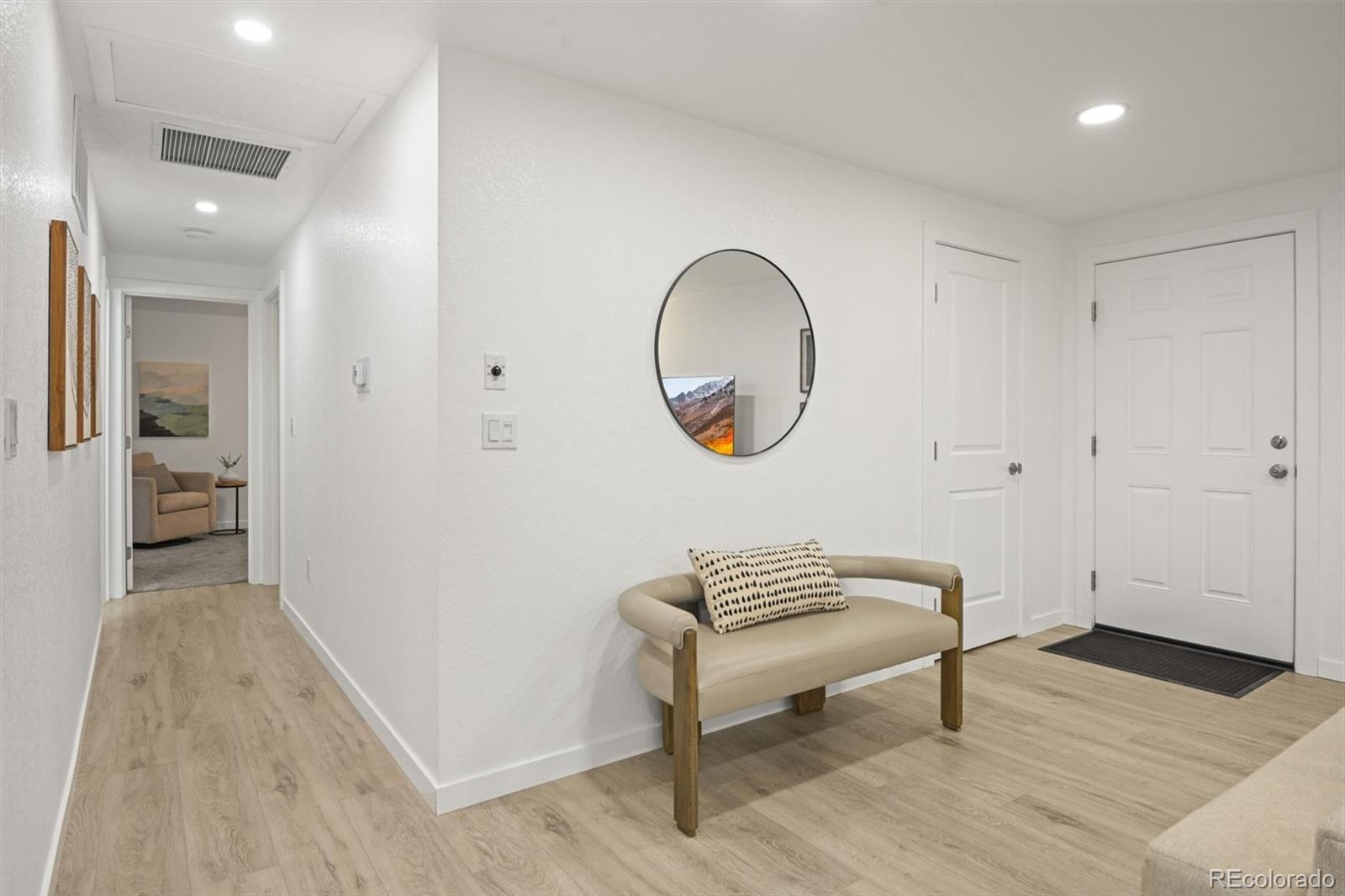 9340 Pierce Street Westminster, CO 80021 - Photo 11 of 29 wooden floor in a hall with a window and a mirror
