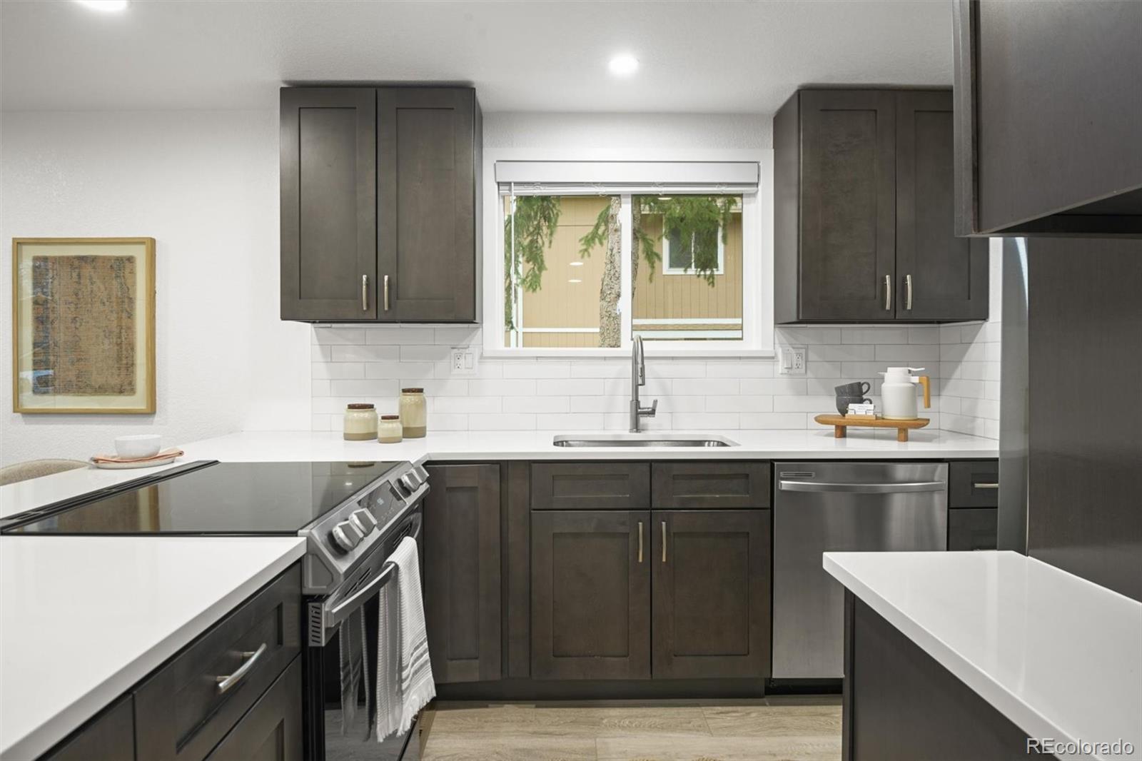 9340 Pierce Street Westminster, CO 80021 - Photo 12 of 29 a kitchen with a sink stove and refrigerator