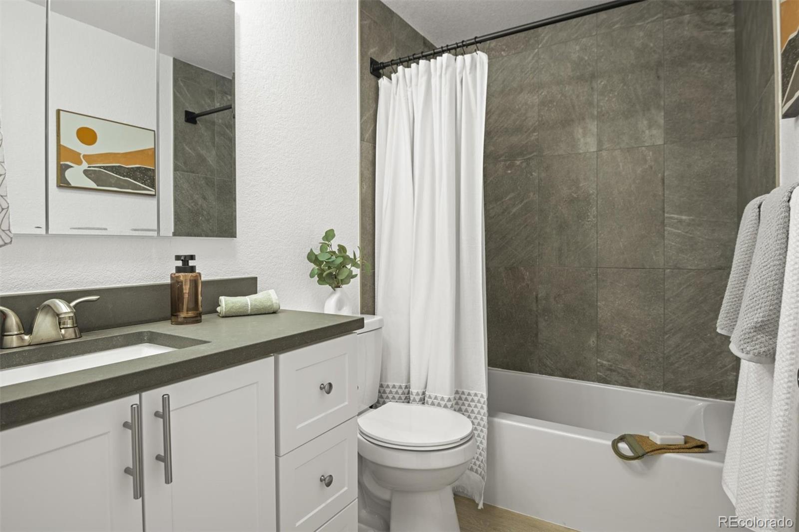 9340 Pierce Street Westminster, CO 80021 - Photo 17 of 29 a bathroom with a sink a toilet and shower