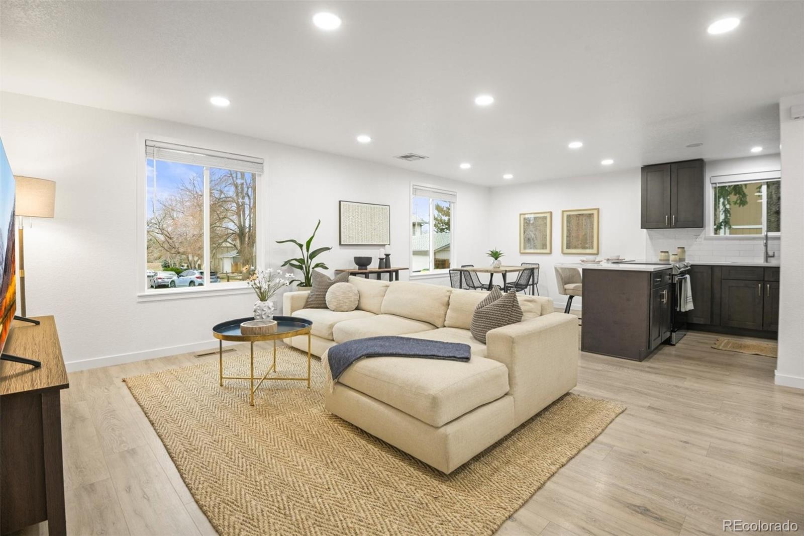 9340 Pierce Street Westminster, CO 80021 - Photo 2 of 29 a living room with furniture a dining table and kitchen view