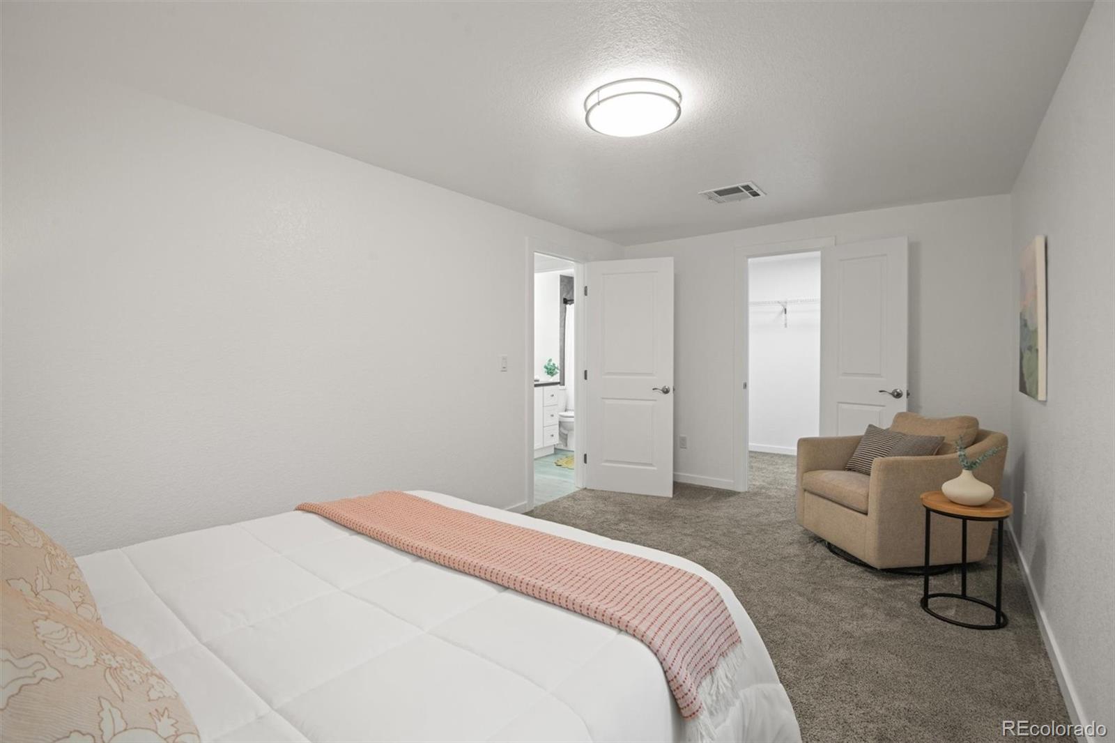 9340 Pierce Street Westminster, CO 80021 - Photo 22 of 29 a spacious bedroom with a bed and a couch