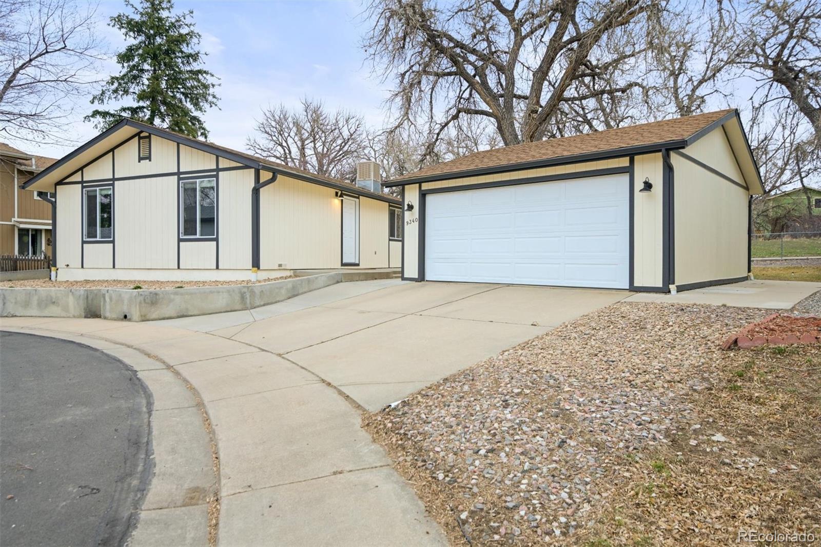 9340 Pierce Street Westminster, CO 80021 - Photo 23 of 29 a front view of a house with a yard and garage