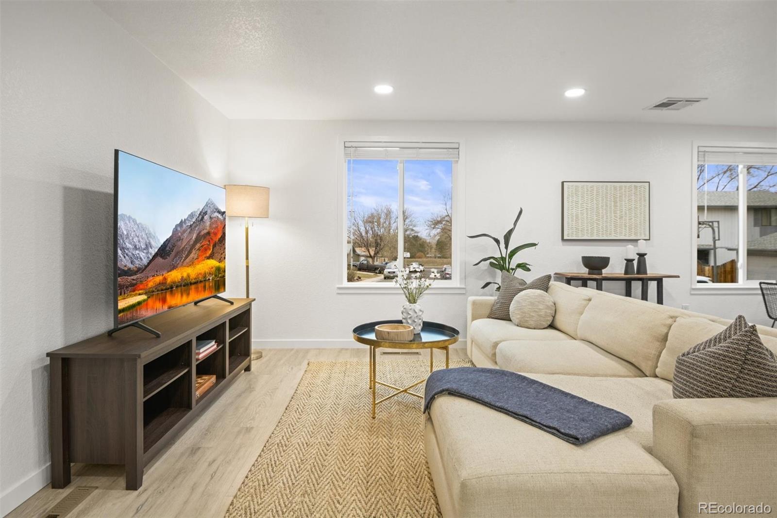 9340 Pierce Street Westminster, CO 80021 - Photo 4 of 29 a living room with furniture and a flat screen tv