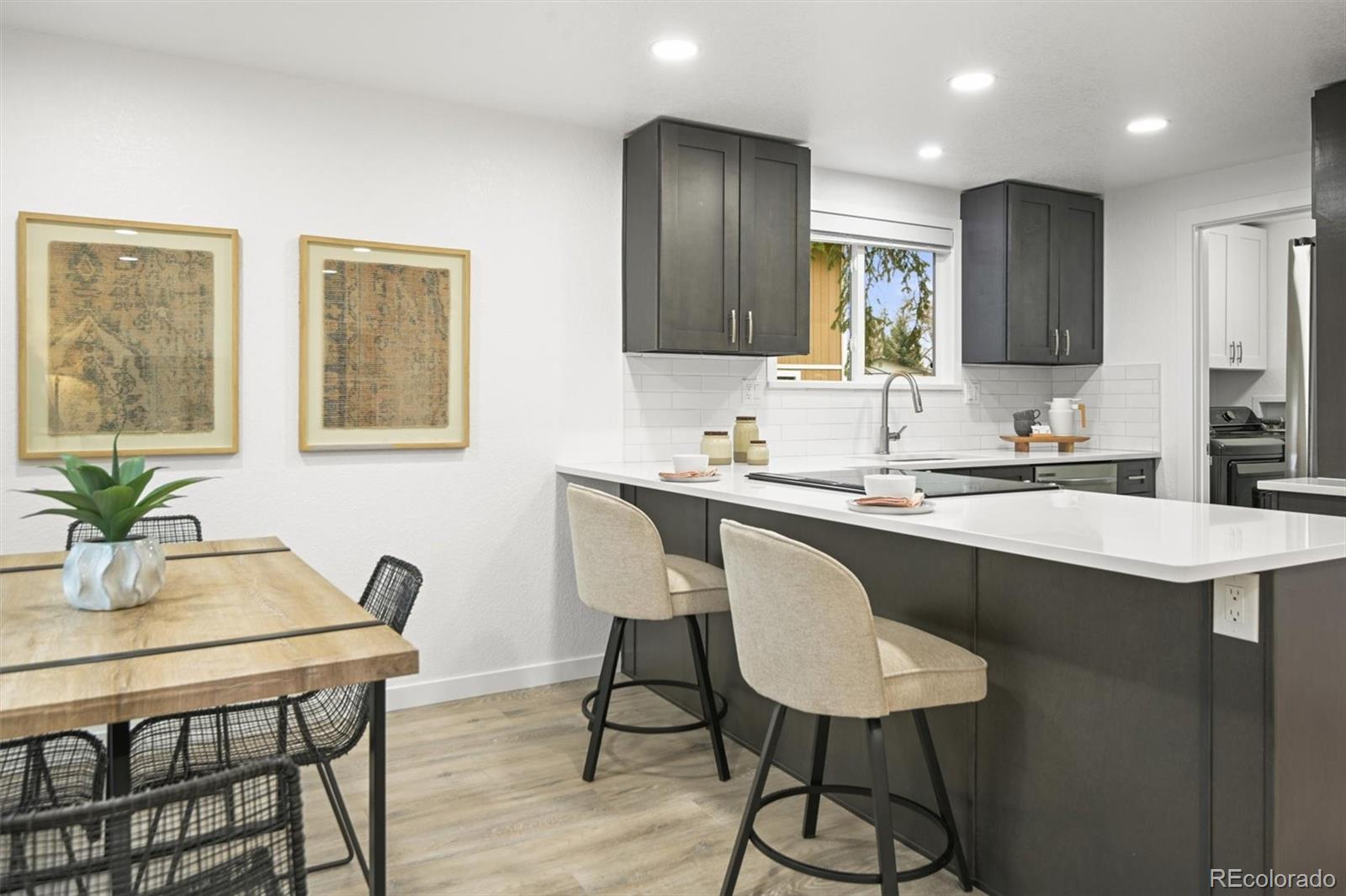 9340 Pierce Street Westminster, CO 80021 - Photo 8 of 29 a kitchen with a table chairs sink and cabinets