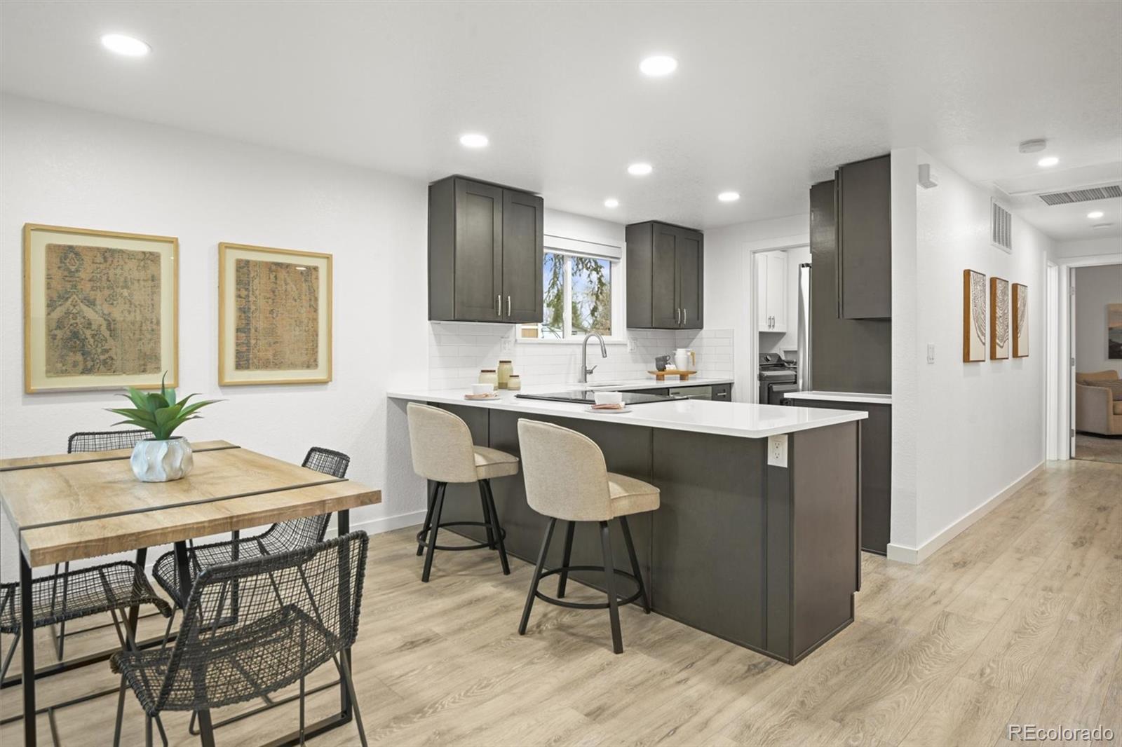 9340 Pierce Street Westminster, CO 80021 - Photo 9 of 29 a kitchen with a dining table chairs and refrigerator