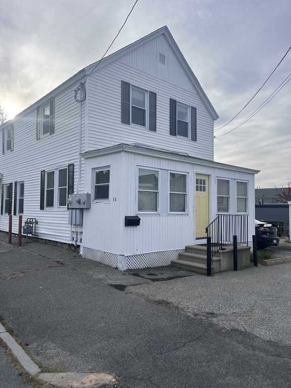 11 2nd Street, Unit 1 North Andover, MA 01845 - Photo 2 of 24 a white building with a large window and car parked