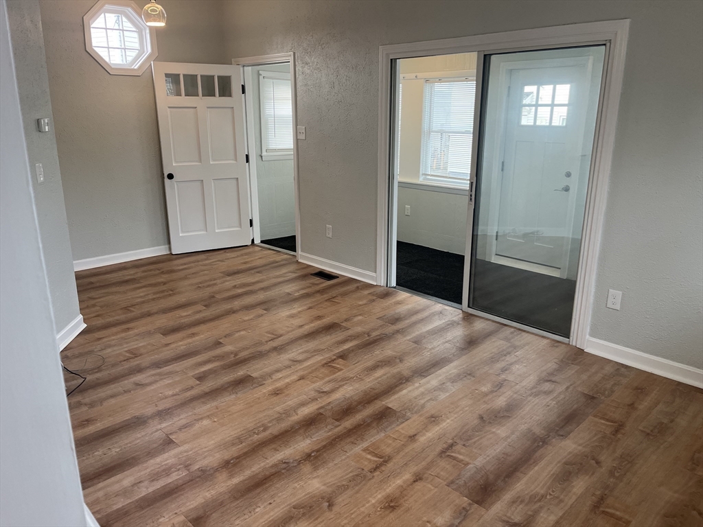11 2nd Street, Unit 1 North Andover, MA 01845 - Photo 5 of 24 a view of empty room with window and wooden floor