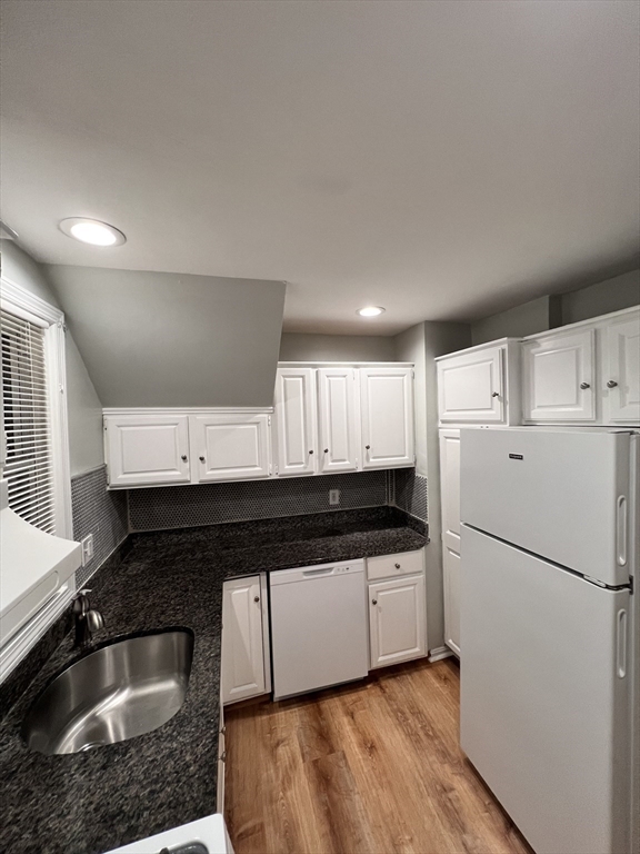 11 2nd Street, Unit 1 North Andover, MA 01845 - Photo 7 of 24 a kitchen with granite countertop a refrigerator sink and white cabinets