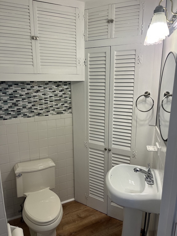 11 2nd Street, Unit 1 North Andover, MA 01845 - Photo 9 of 24 a bathroom with a sink a toilet and mirror