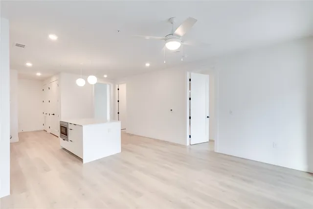 a kitchen with a sink a stove and cabinets