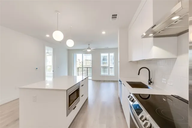 a kitchen with a sink cabinets and wooden floor