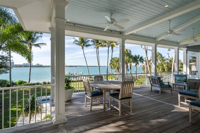 a dining room with furniture a chandelier and wooden floor