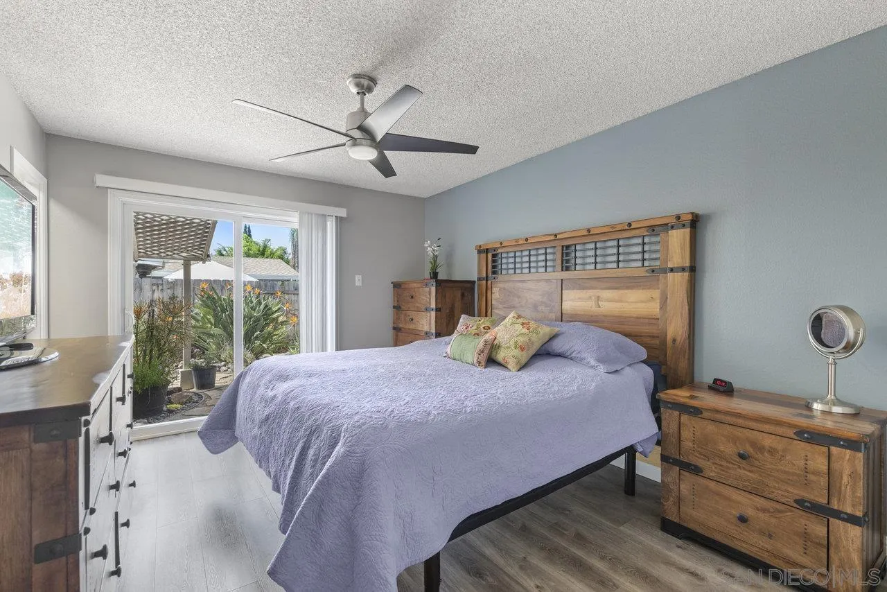 13344 Racquet Court Poway, CA 92064 - Photo 12 of 29 a bedroom with a bed and large windows