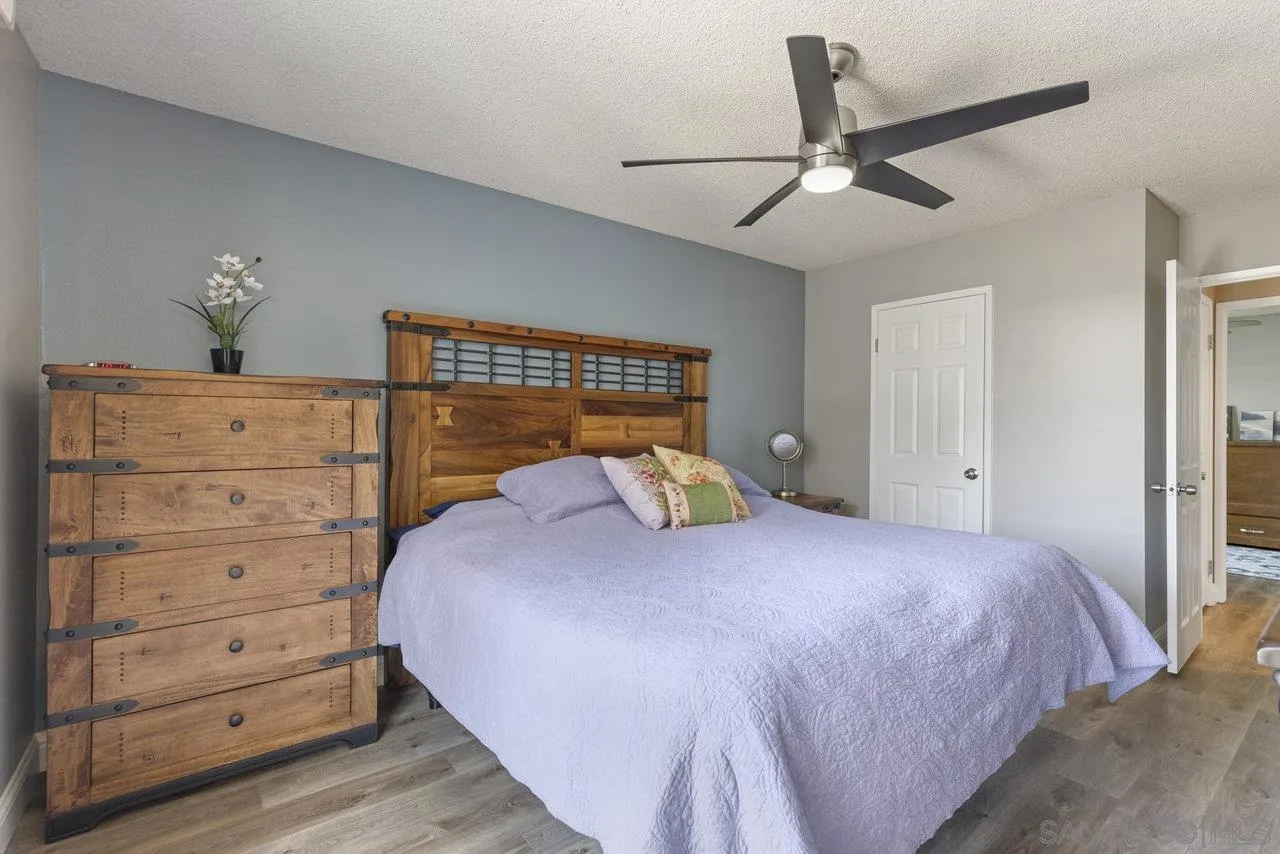 13344 Racquet Court Poway, CA 92064 - Photo 13 of 29 a bedroom with a bed and a chandelier