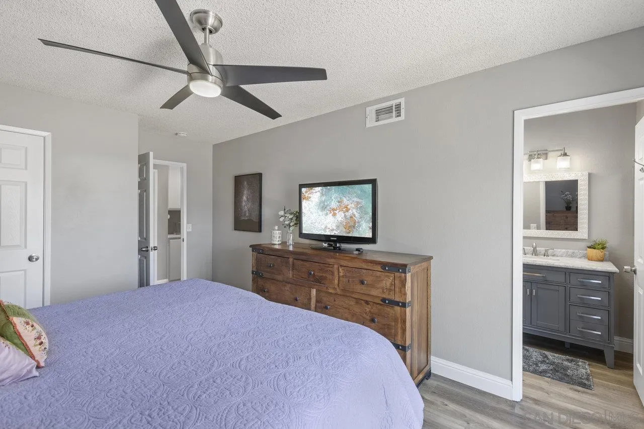 13344 Racquet Court Poway, CA 92064 - Photo 14 of 29 a bedroom with a bed and a flat screen tv
