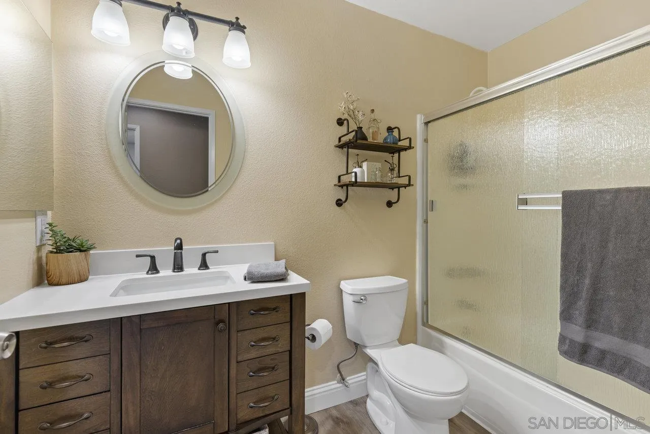 13344 Racquet Court Poway, CA 92064 - Photo 20 of 29 a bathroom with a toilet a sink and mirror