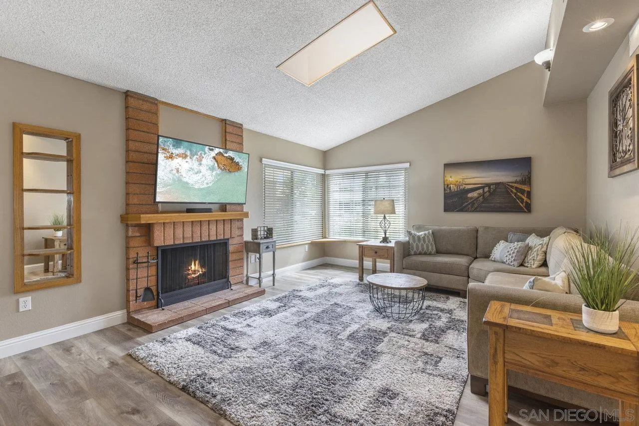 13344 Racquet Court Poway, CA 92064 - Photo 4 of 29 a living room with furniture a flat screen tv and a fireplace