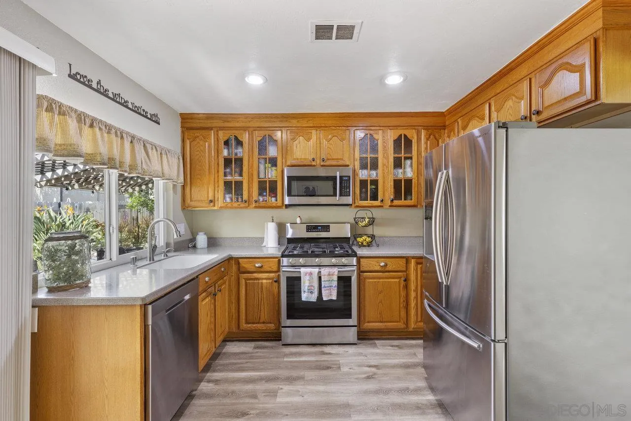 13344 Racquet Court Poway, CA 92064 - Photo 7 of 29 a kitchen with stainless steel appliances granite countertop a refrigerator and a stove