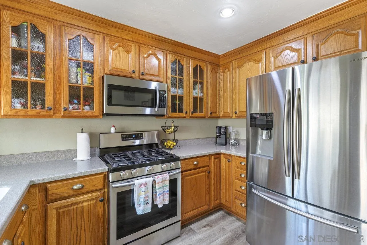 13344 Racquet Court Poway, CA 92064 - Photo 9 of 29 a kitchen with stainless steel appliances granite countertop a refrigerator stove and sink