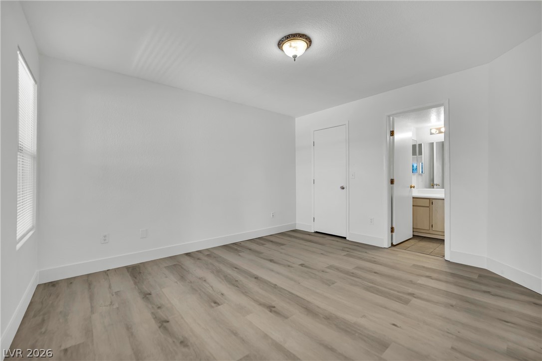 8101 West Flamingo Road, Unit 2030 Las Vegas, NV 89147 - Photo 21 of 27 A quiet bedroom retreat features durable flooring and a private entrance to the adjacent bath.