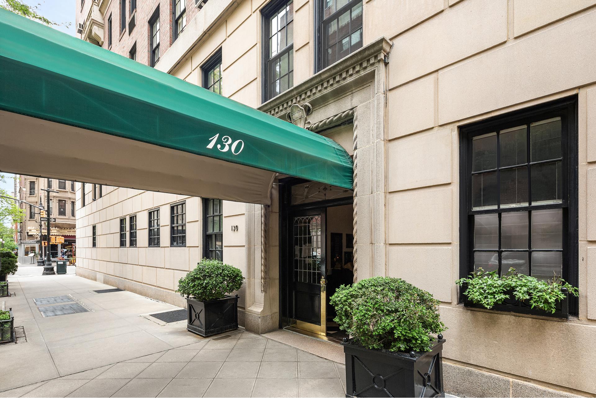 130 East 75th Street, Unit 5A Manhattan, NY 10021 - Photo 11 of 12 a front view of a building with potted plants