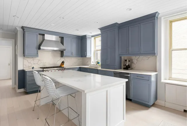 a kitchen with a stove a sink and a refrigerator