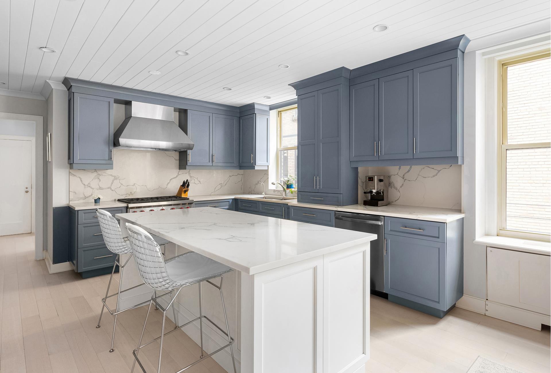 130 East 75th Street, Unit 5A Manhattan, NY 10021 - Photo 4 of 12 a kitchen with a stove a sink and a refrigerator