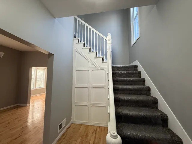 a view of entryway and hall with wooden floor