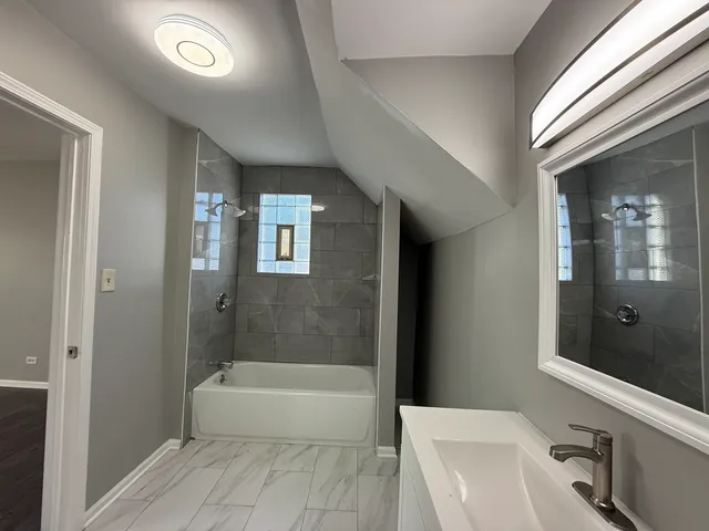 a bathroom with a bathtub and a sink