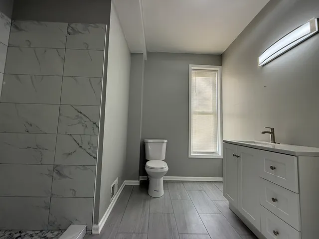 a bathroom with a toilet sink and a window