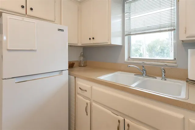 a white refrigerator freezer sitting inside of a kitchen