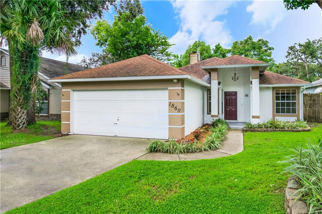 1860 White Avenue Orlando, FL 32806 - Photo 1 of 1 a front view of a house with a yard and garage