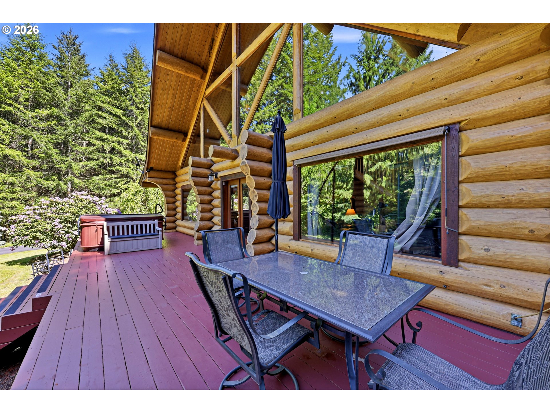 390 Spruce Creek Road Longview, WA 98632 - Photo 9 of 45 a view of a patio with table and chairs with wooden floor and plants