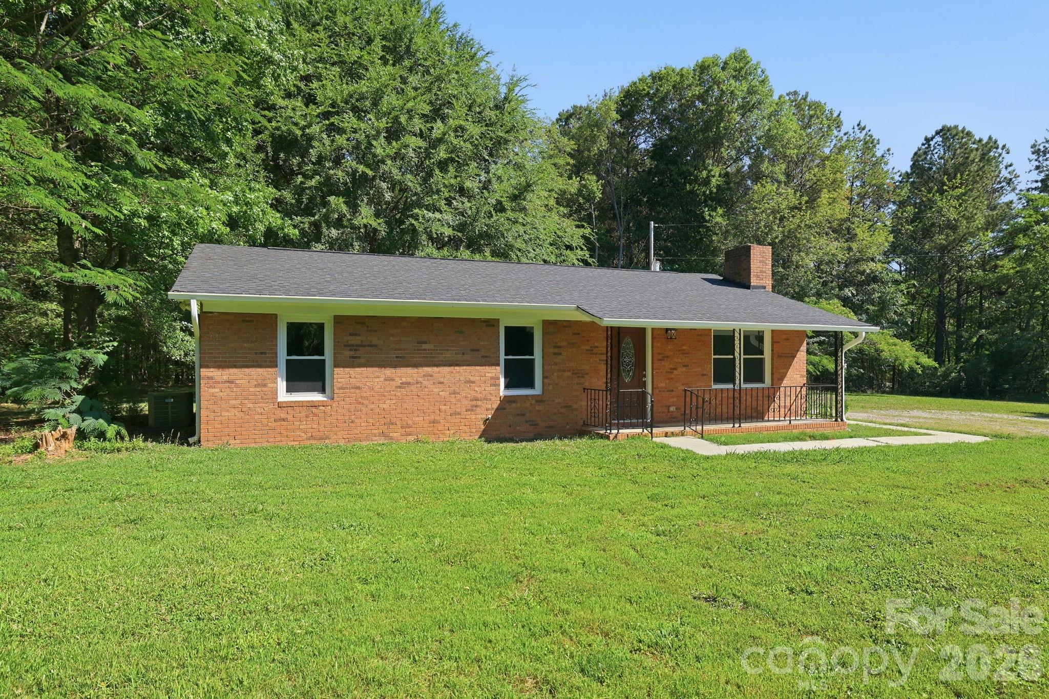 1108 Willoughby Road Monroe, NC 28110 - Photo 3 of 48 a front view of a house with a garden
