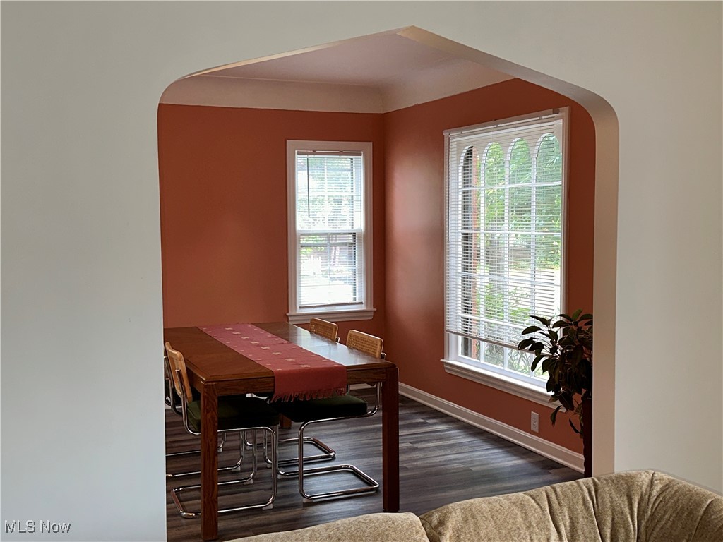 3498 Cummings Road Cleveland, OH 44118 - Photo 5 of 22 Dining room featuring arched walkways and dark wood-style floors